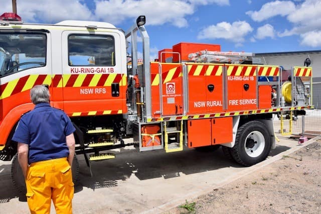 Rural Fire Service fireman turned away facing fire truck