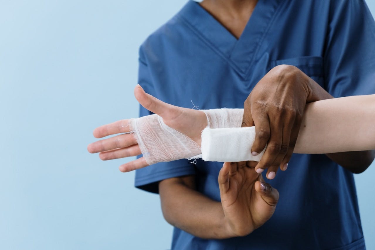 Health professional bandaging a patient's wrist